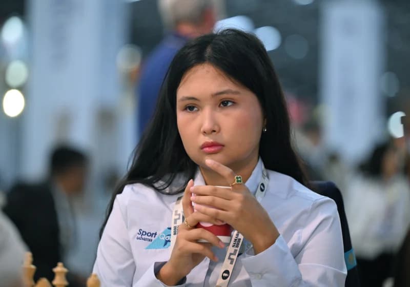 Woman holding a cup during an indoor competition