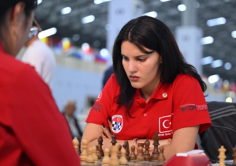 Woman playing chess at a tournament