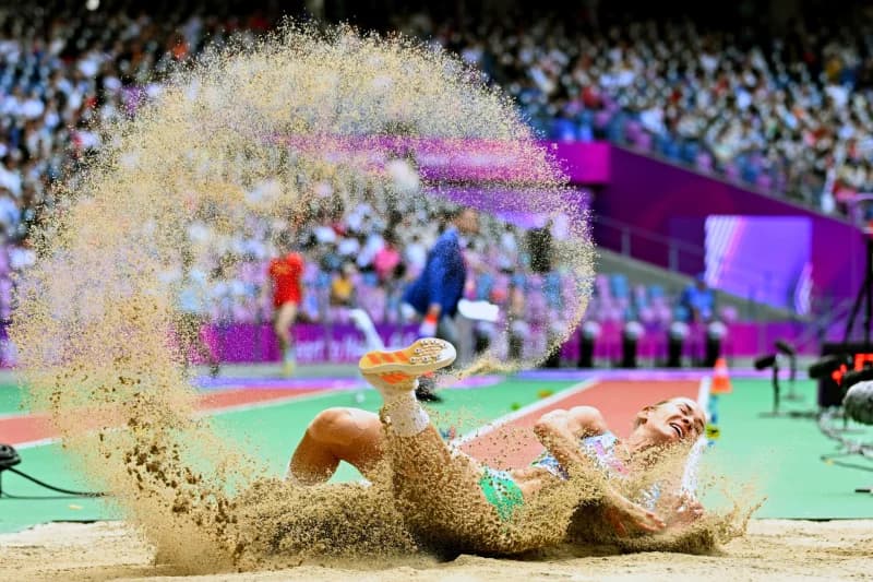 Athlete landing in sand pit during competition