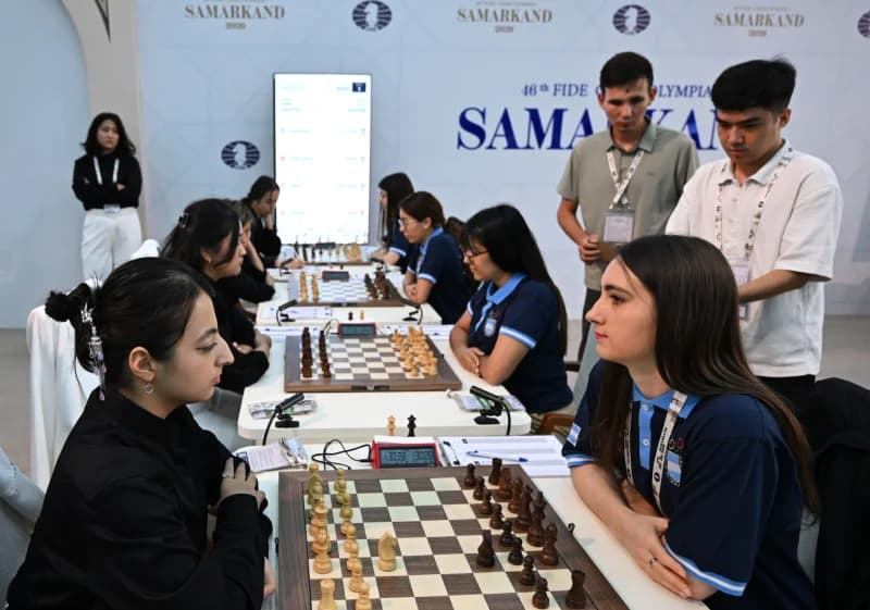 People playing chess at tables in a competition