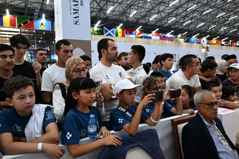 People gathering to watch an event in an indoor venue