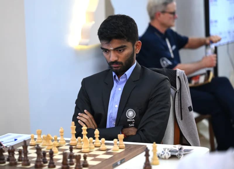 Chess player seated at a board game