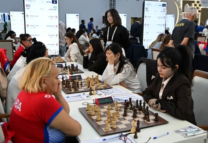 Players compete during a chess tournament in a large hall