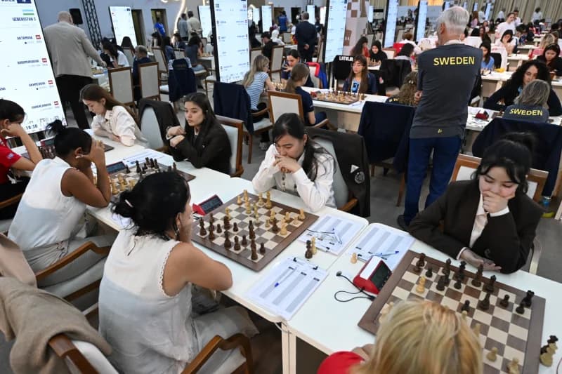 People participating in a chess competition in a hall