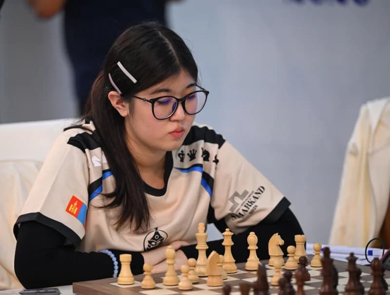 Person playing chess at a table