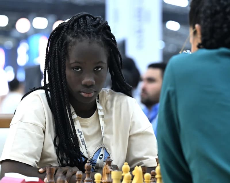 Young participant playing chess at a competition