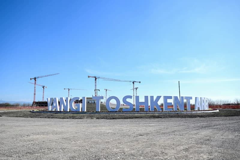 Construction site with large lettering and cranes