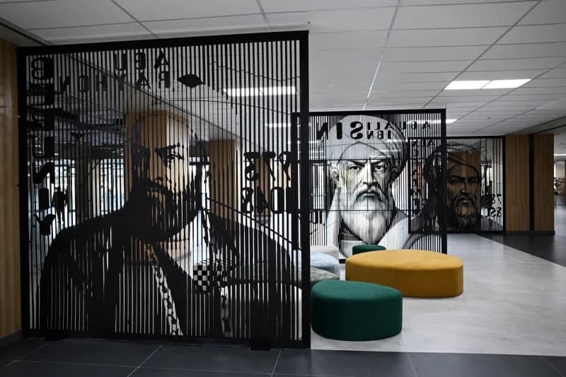 Interior view of an office space featuring decorative dividers with portraits