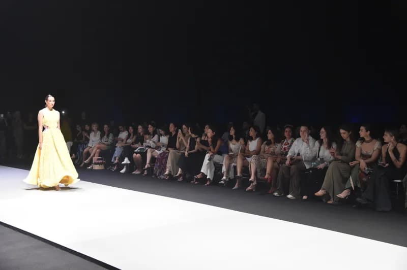 Model walking on runway during fashion show