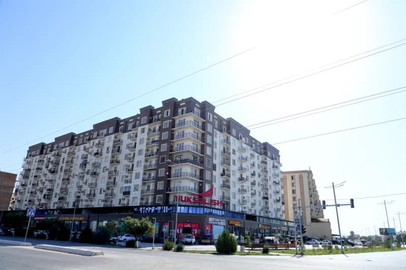 Modern multistory residential and commercial buildings along an urban street