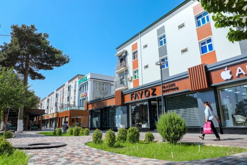 Modern buildings and storefronts along a paved city street