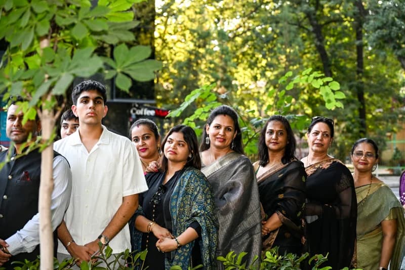 Group of people posing outdoors in a park setting