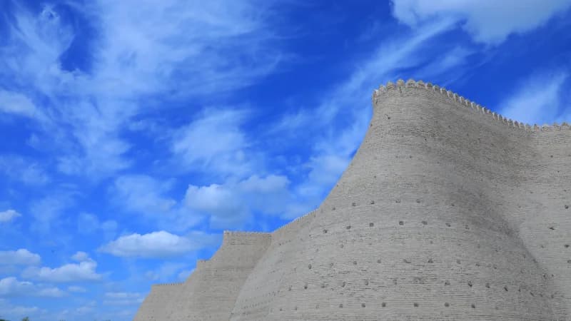 Ancient fortress walls under a bright blue sky