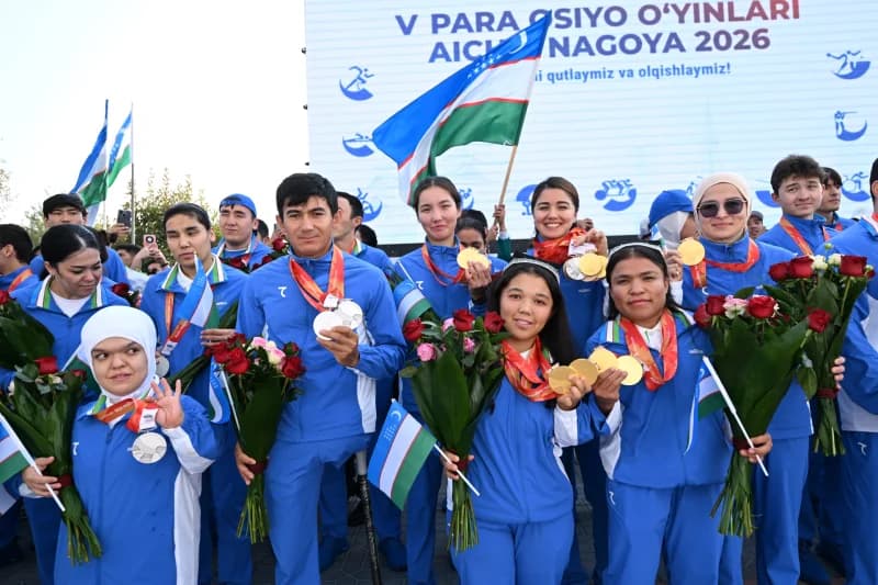Group of athletes holding medals and flowers