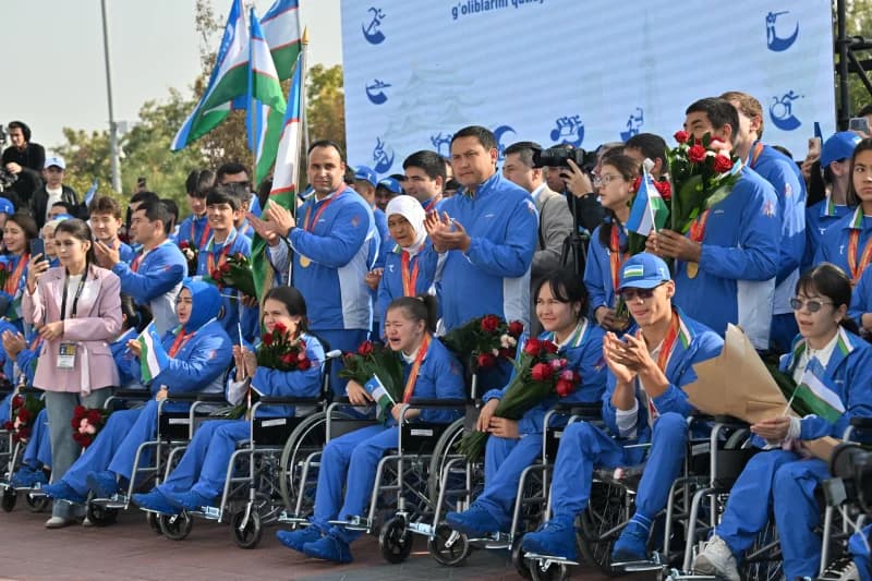 Group of athletes in blue tracksuits during ceremony