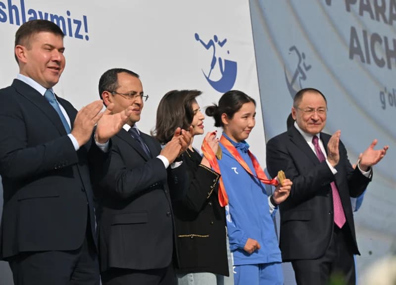 Adham Ikramov clapping during an event