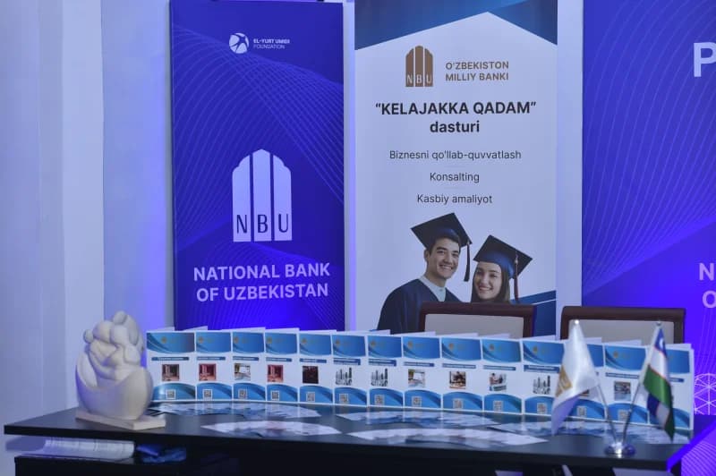 Информационная вывеска с баннерами банка и фонда и печатными материалами на столе