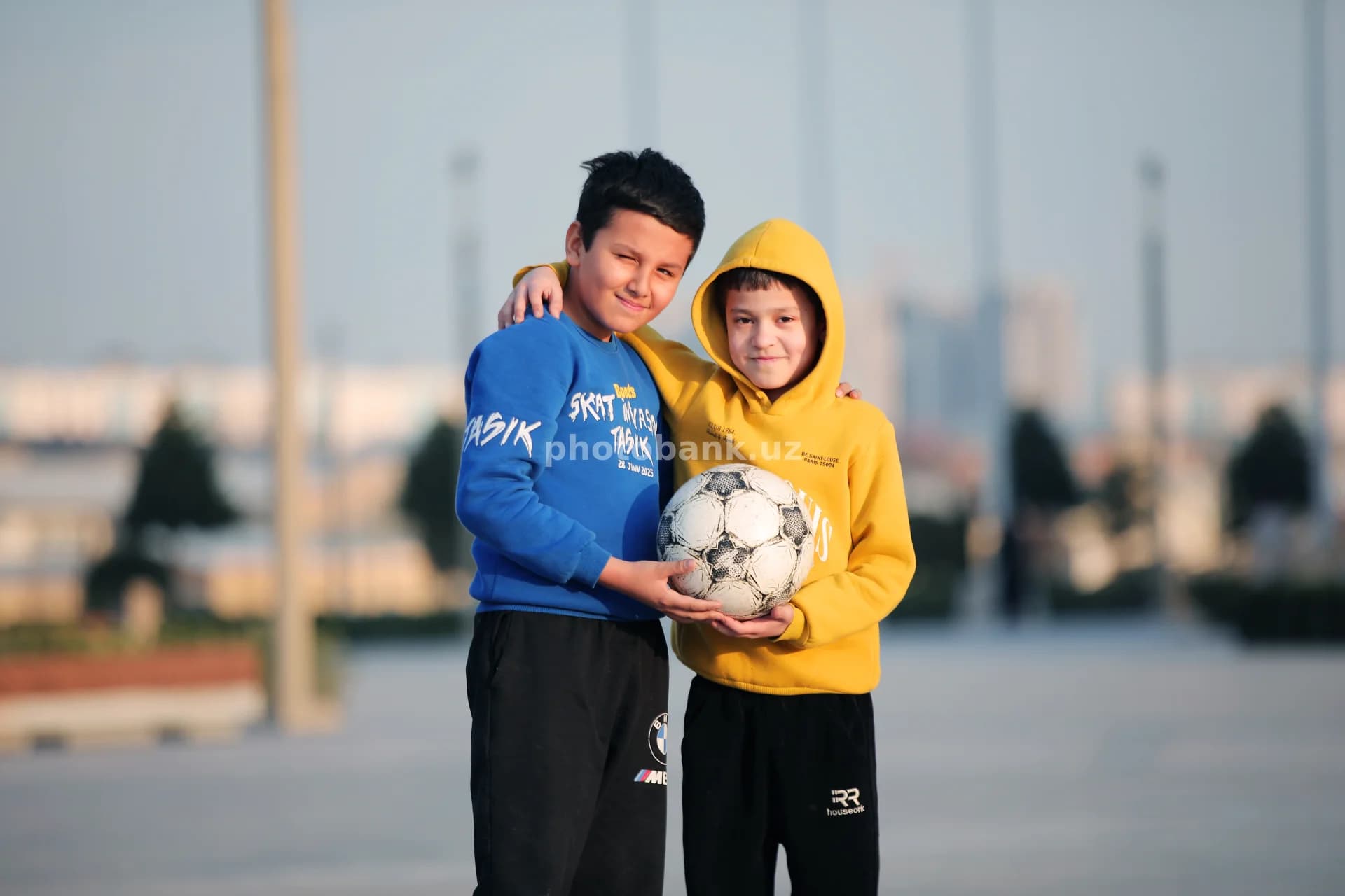 Two boys holding a soccer ball