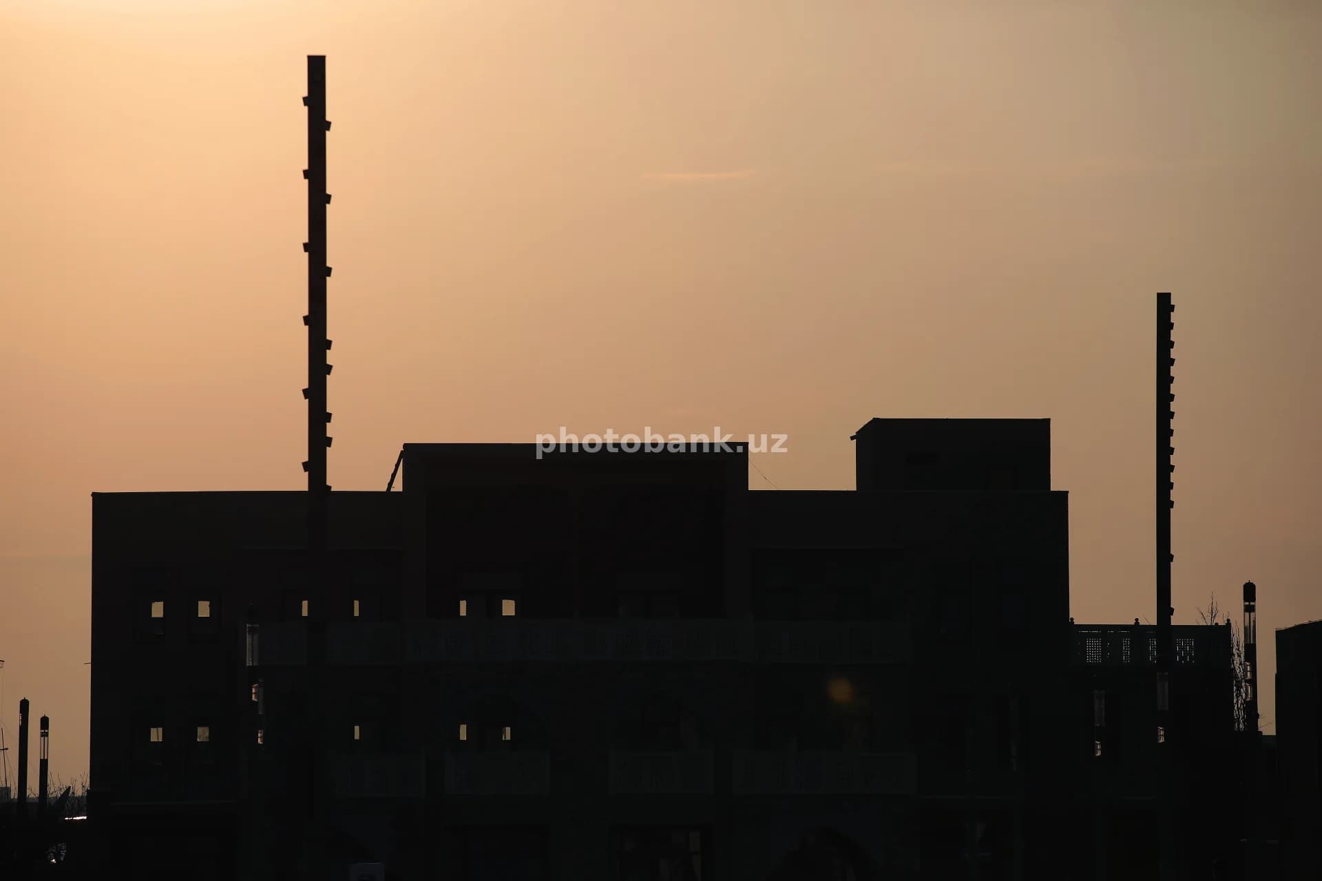 Building silhouette against sunset sky