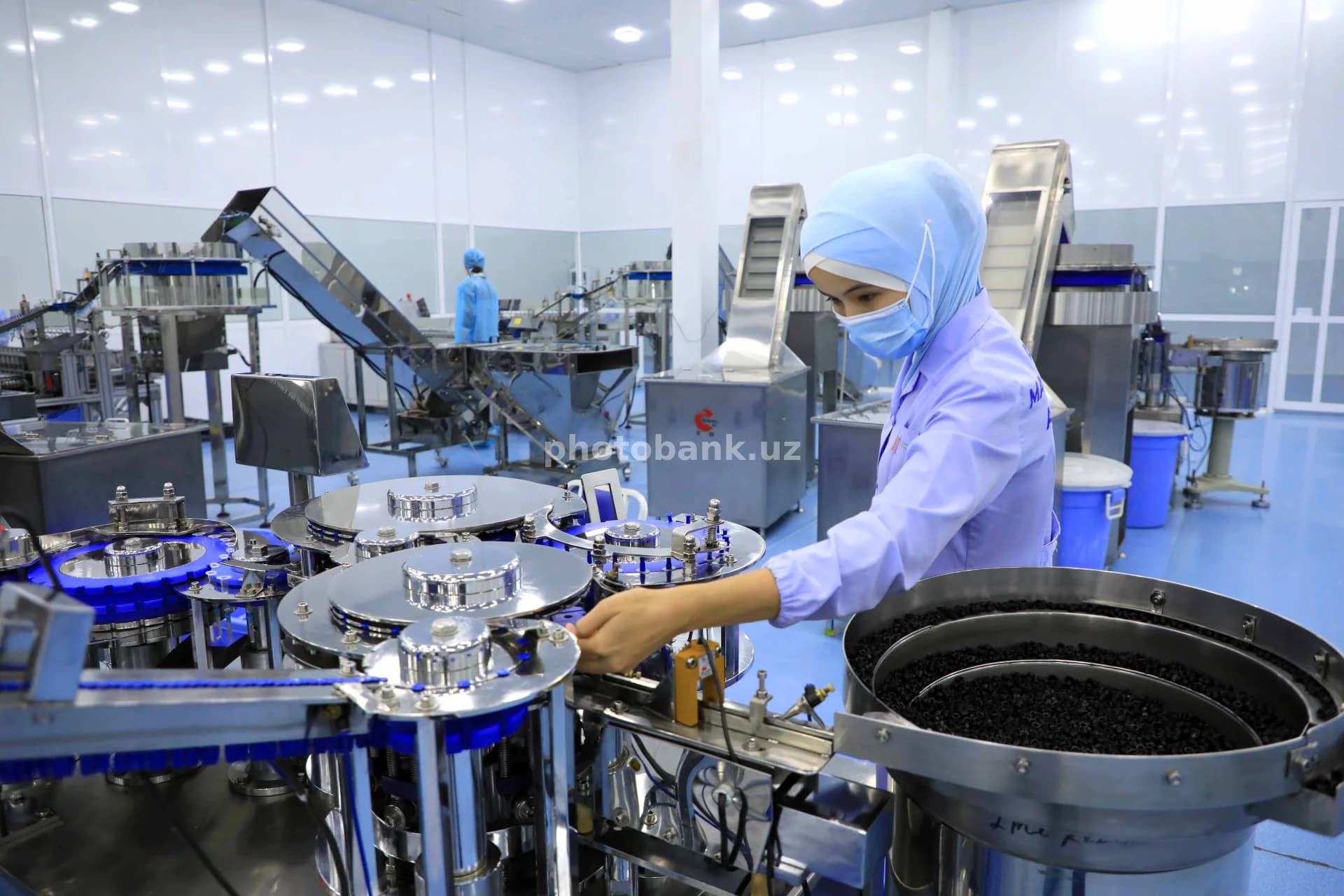 Worker operating pharmaceutical packaging machinery