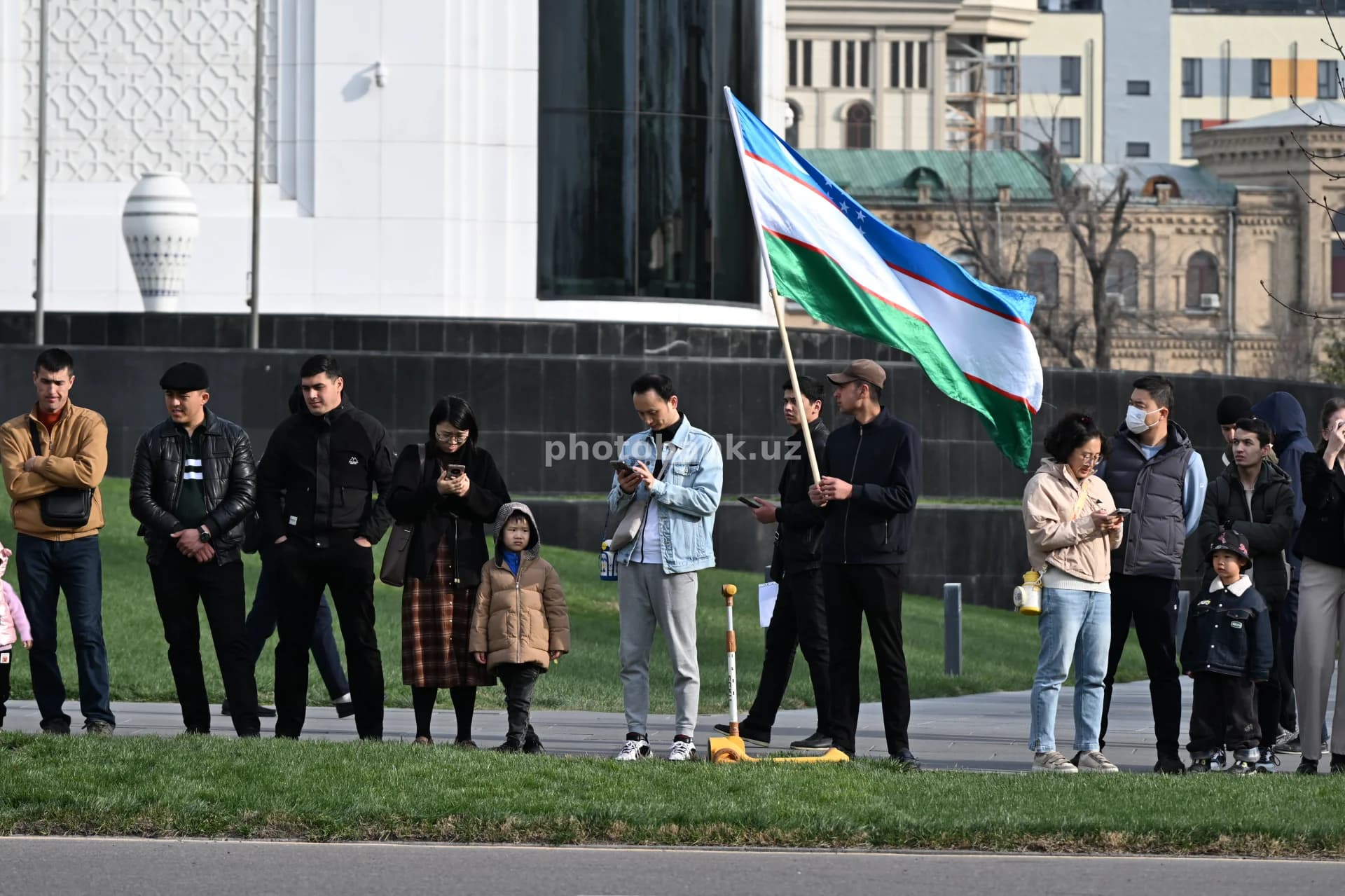 People gathered with Uzbekistan national flag