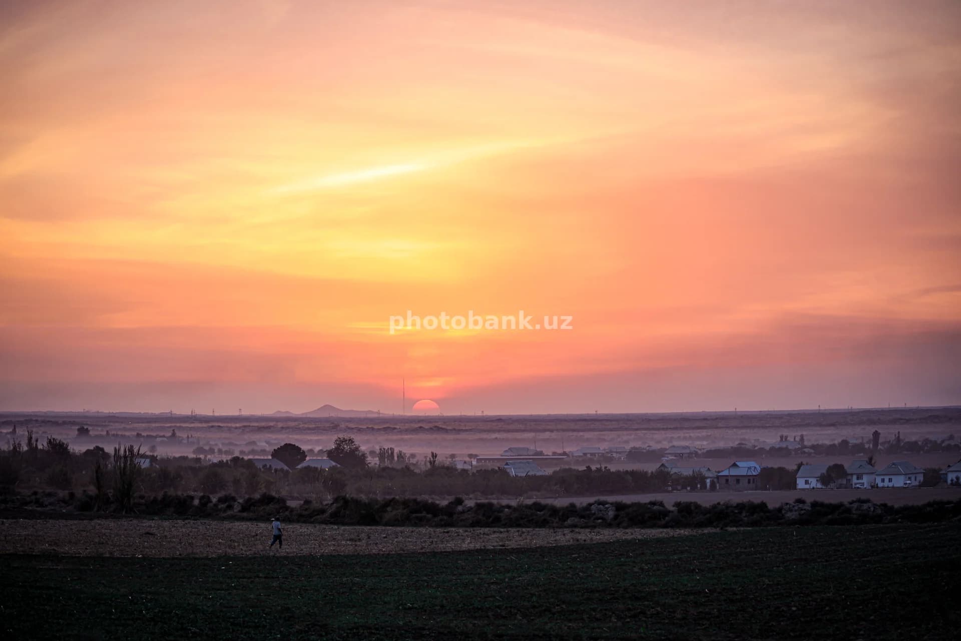 Sunset over a rural village landscape