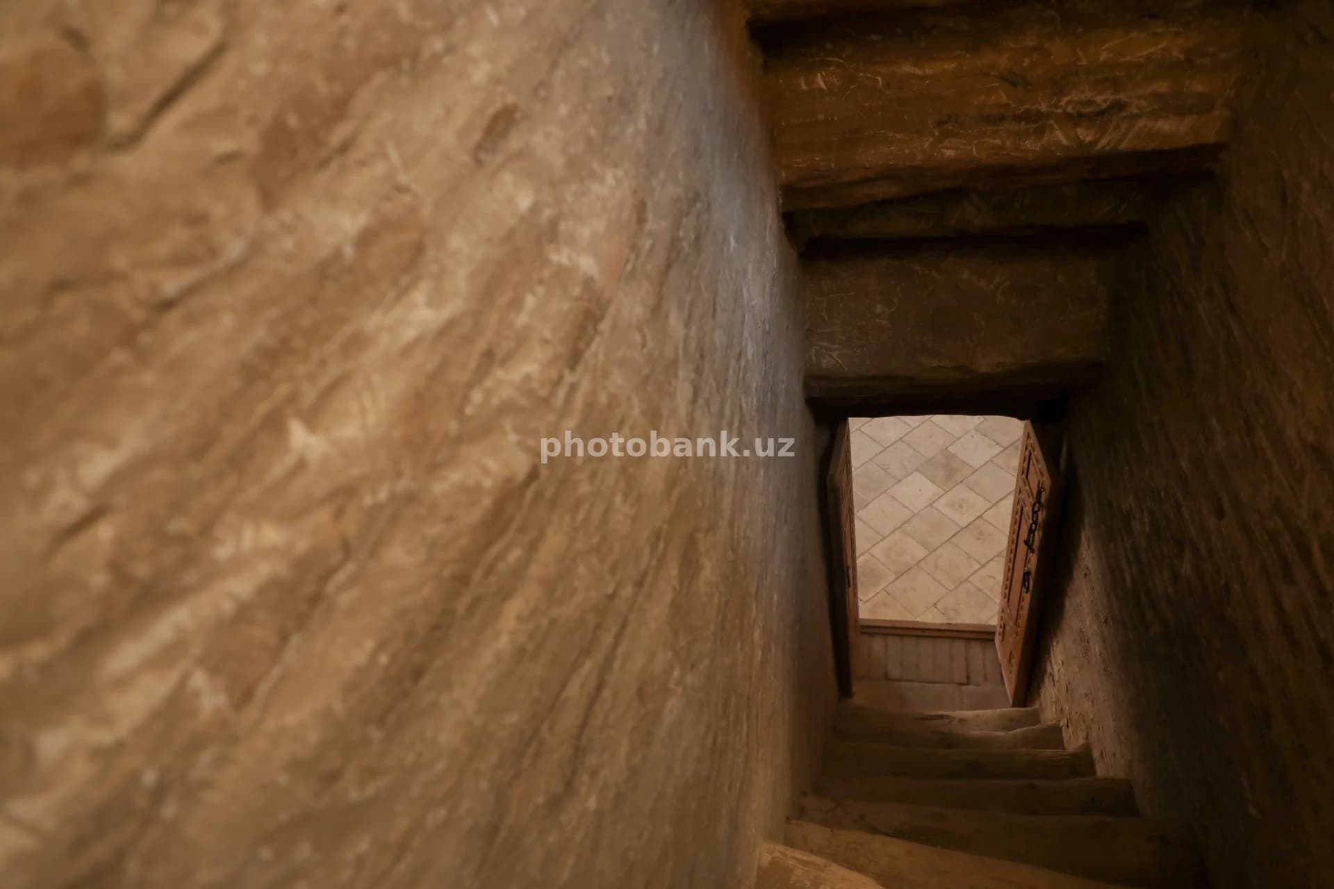 Stone stairs lead toward light