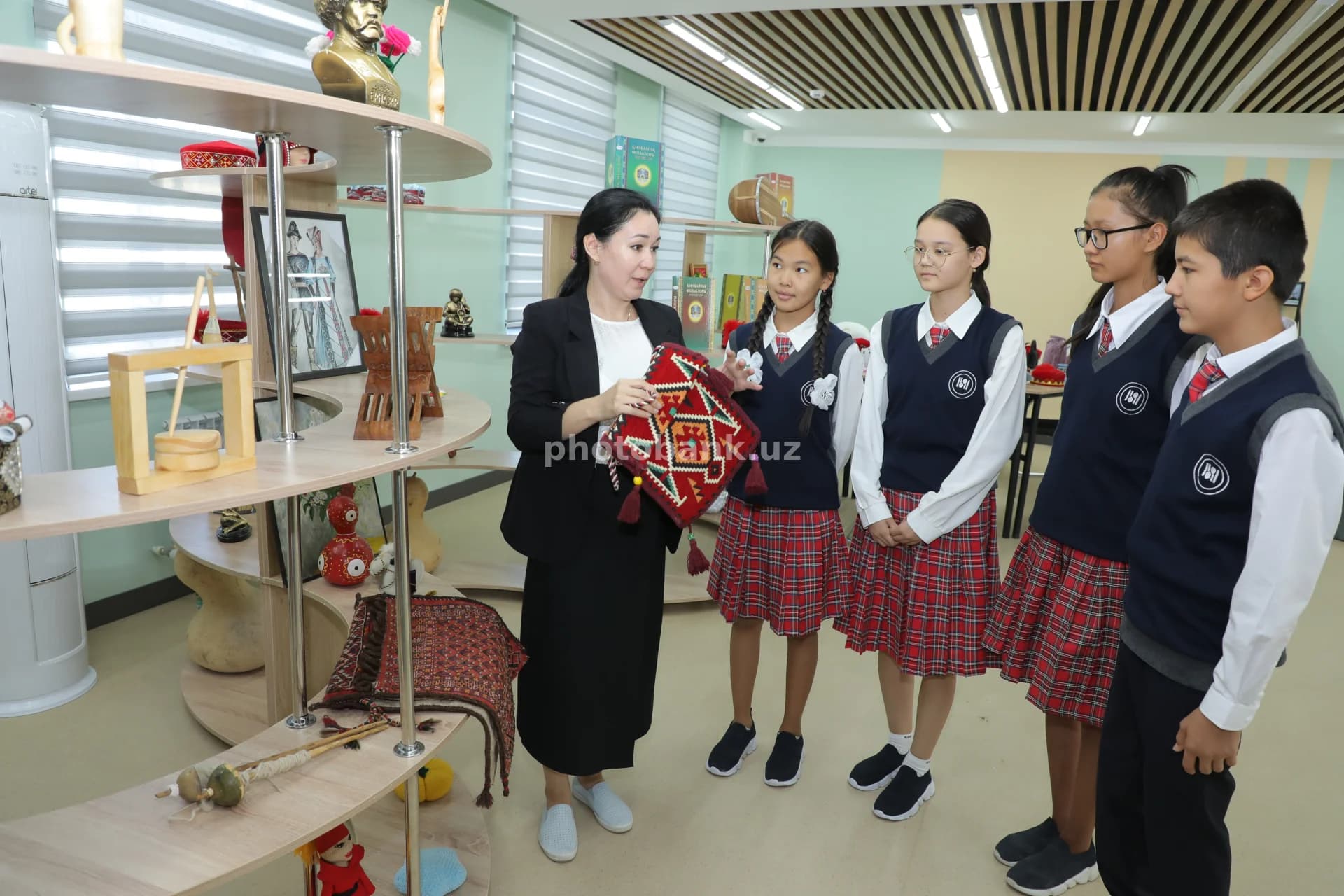 Teacher showing traditional crafts items