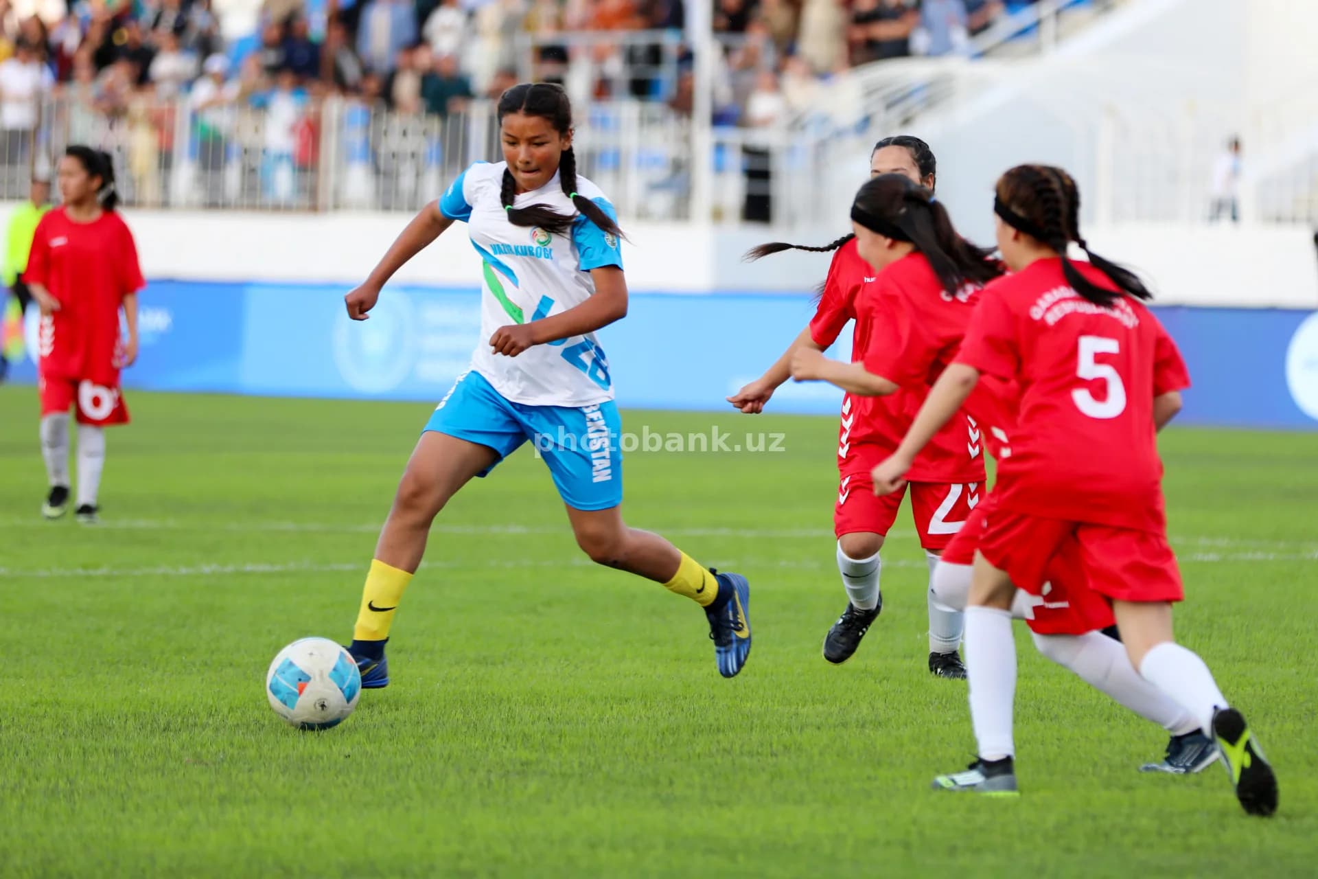 Young female athletes playing football