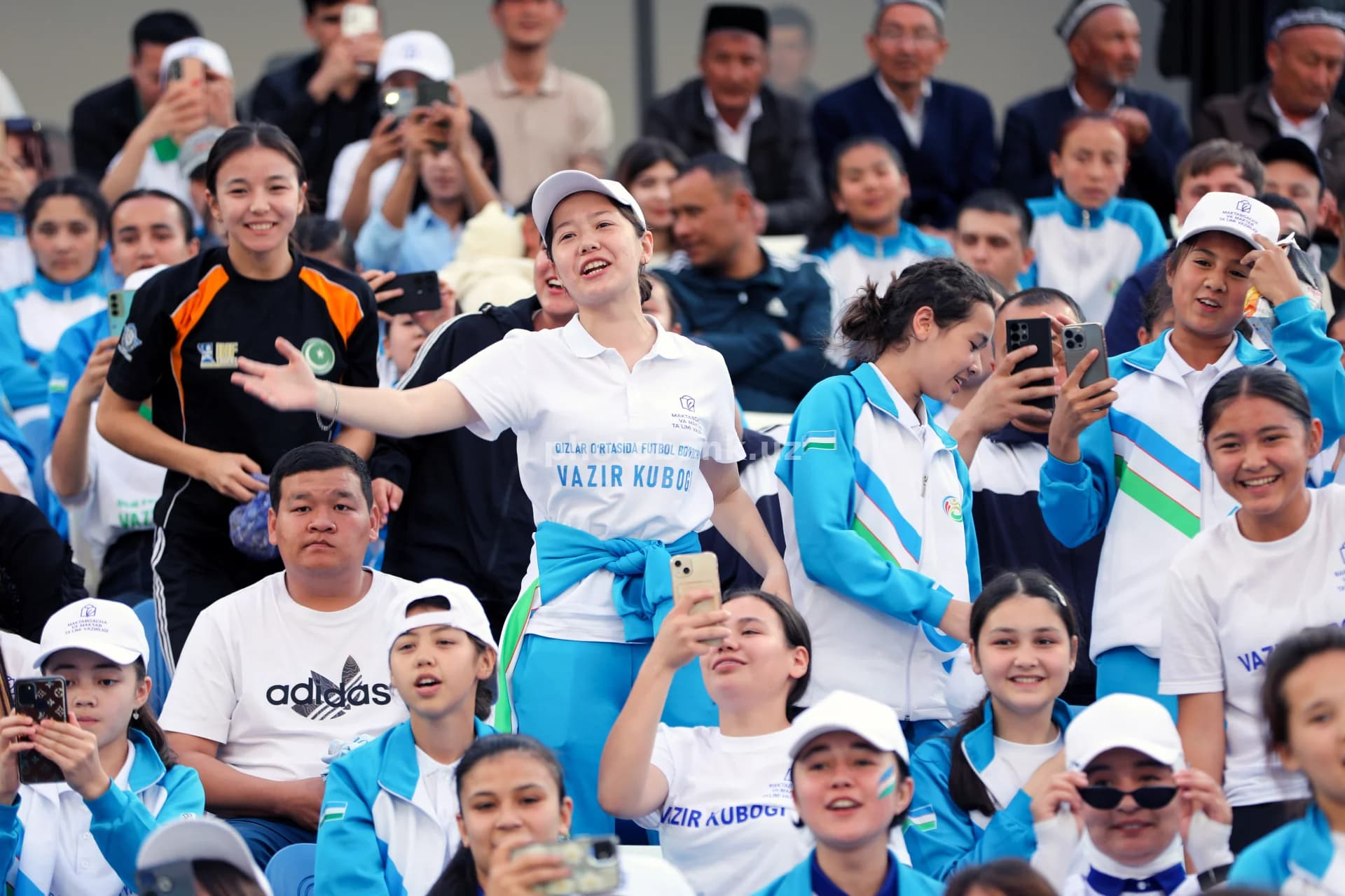 Young women cheering at stadium