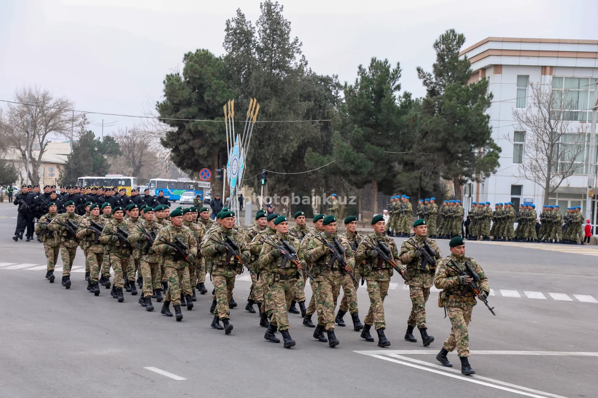 Soldiers march along city street