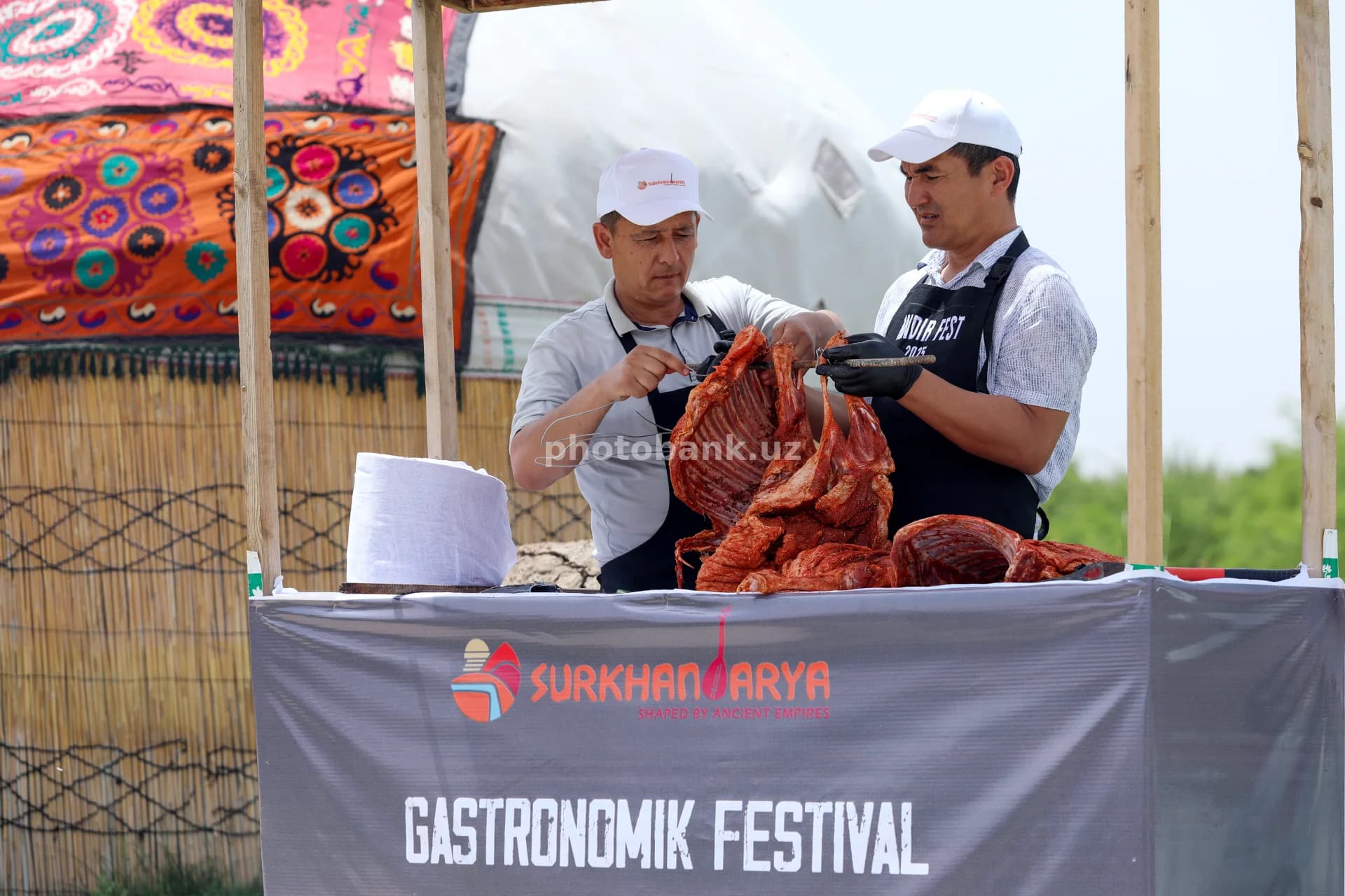 Men preparing meat at festival