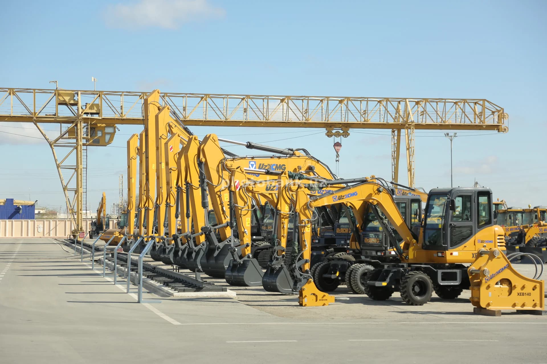 Yellow excavators stand in row