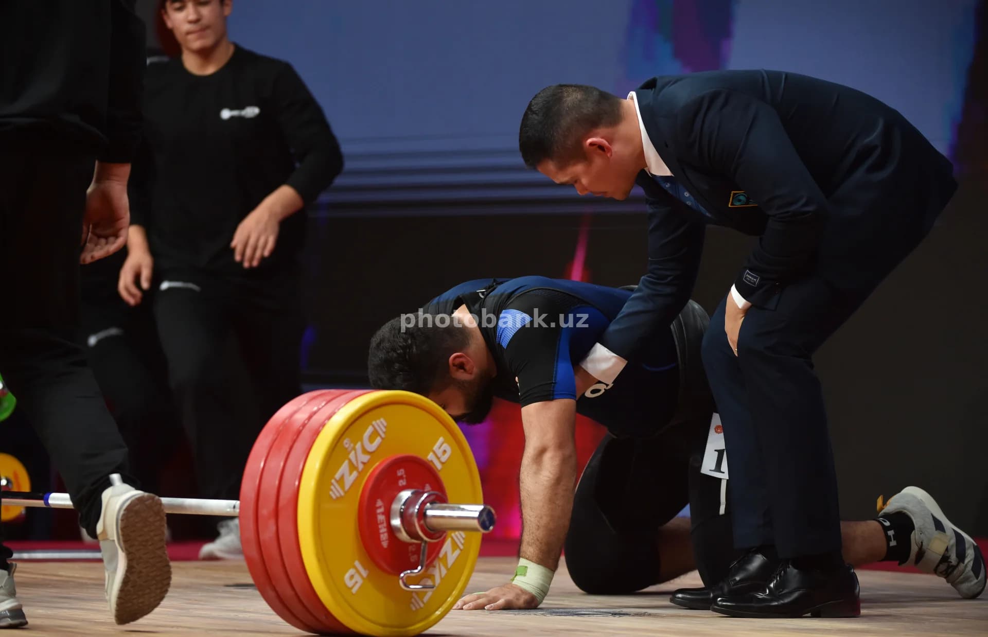 Coach assists athlete during competition