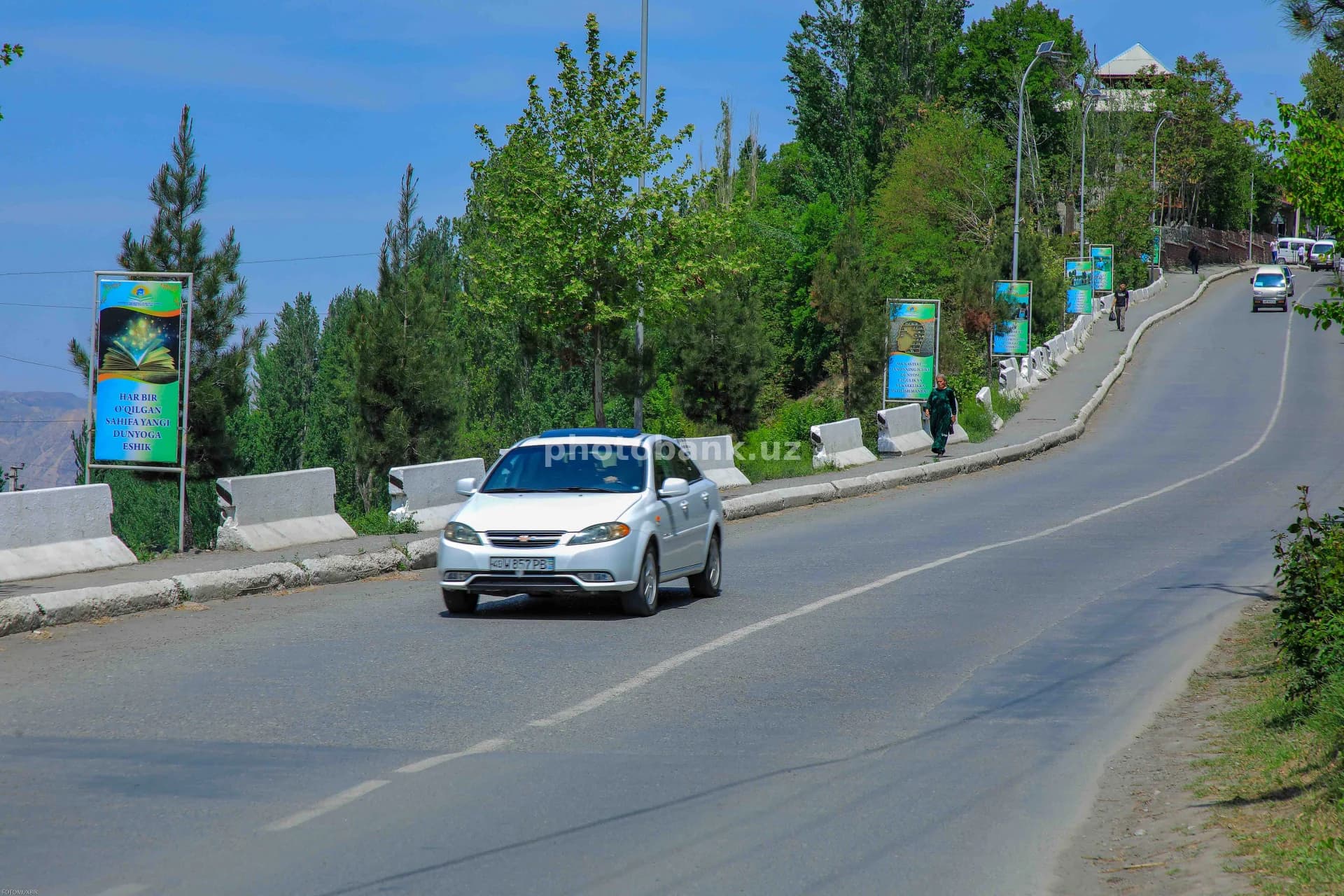 White car driving along road