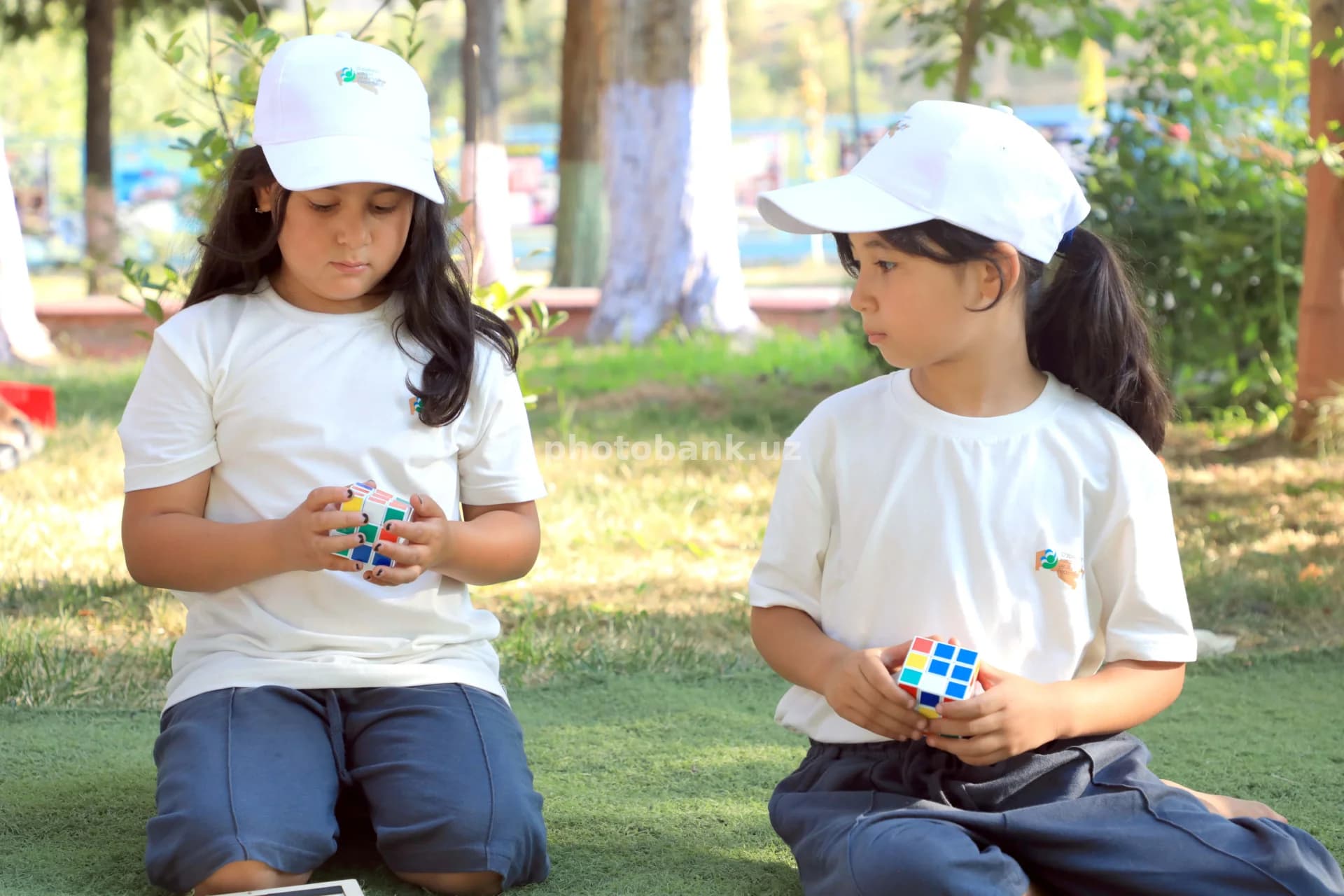 young girls solving puzzle cubes