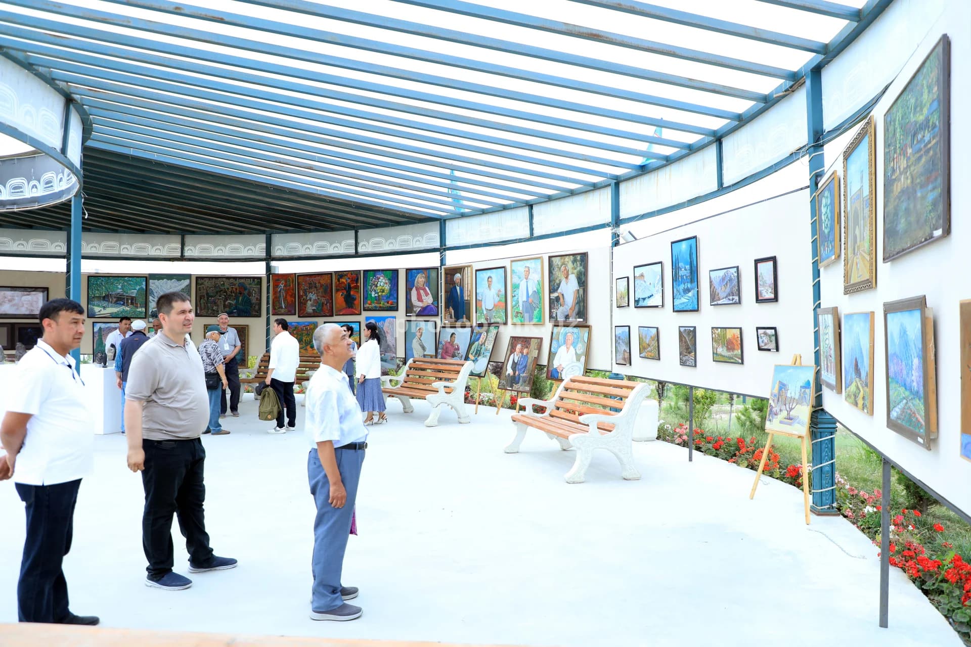 Visitors viewing paintings at exhibition