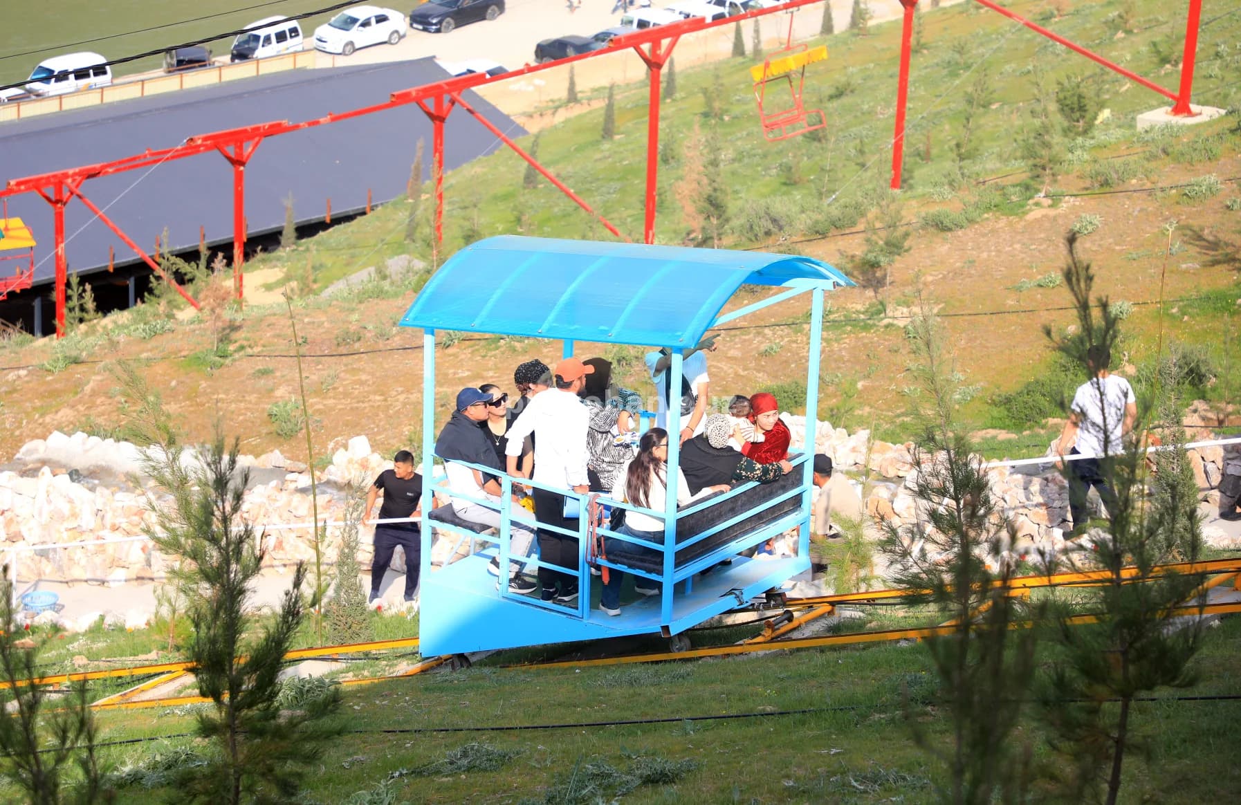 People riding blue funicular car