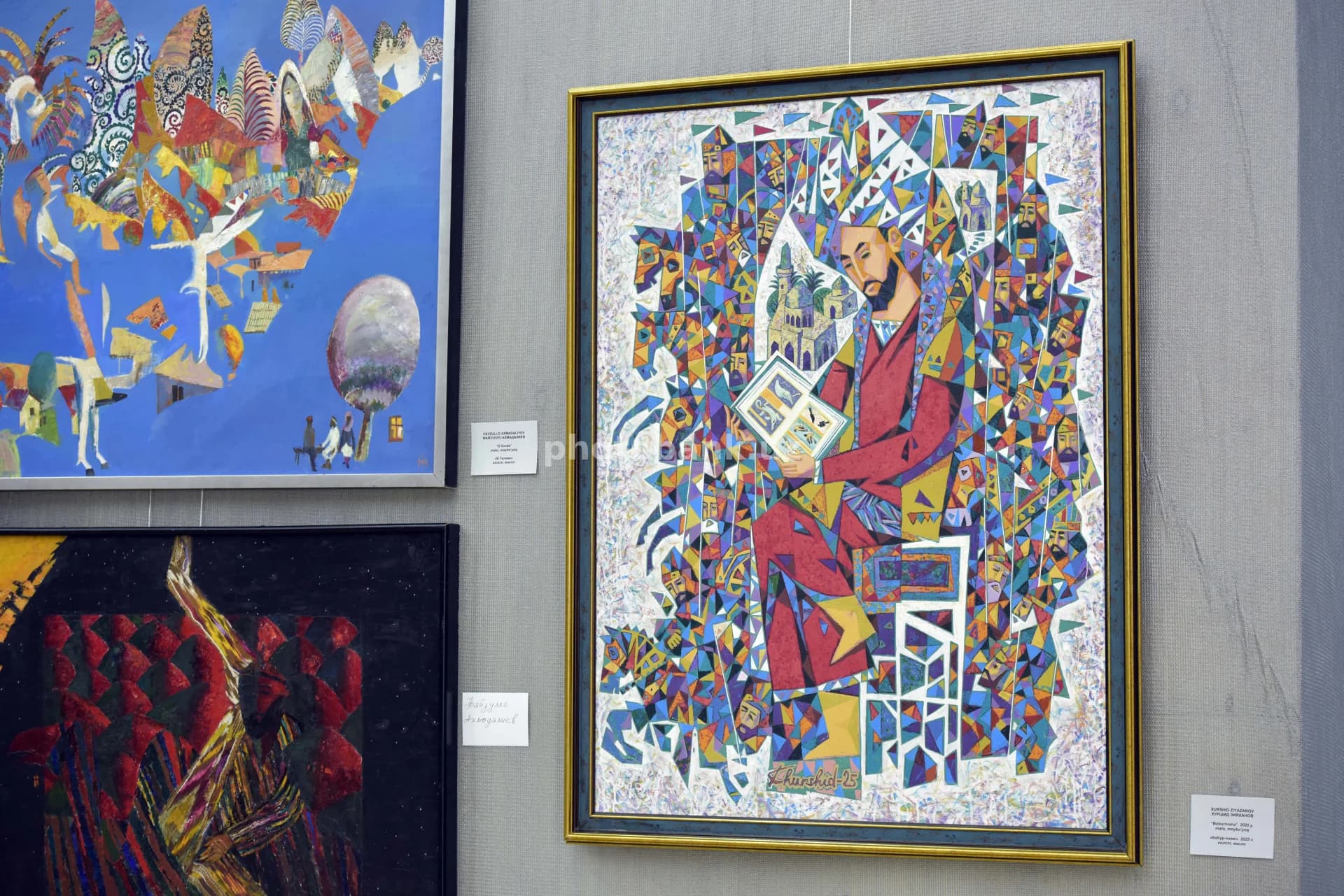 Visitors view paintings in gallery