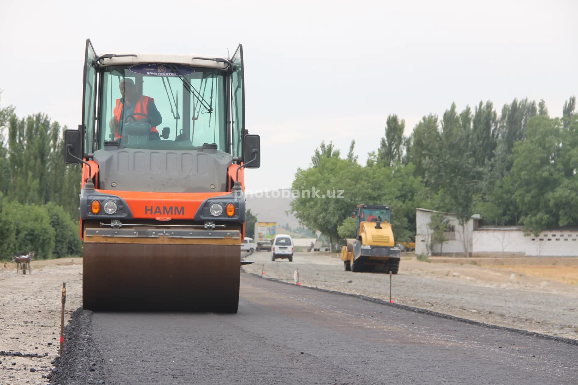 Worker operates heavy road roller