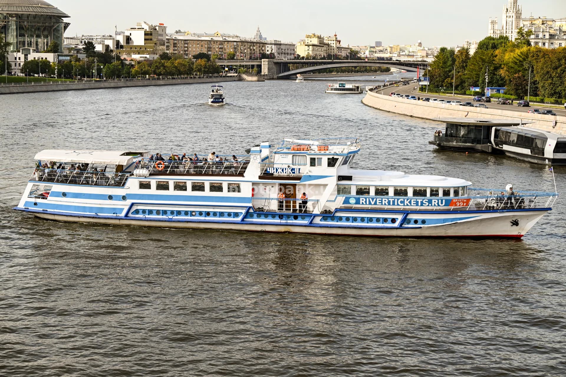 Passenger boat cruises along river