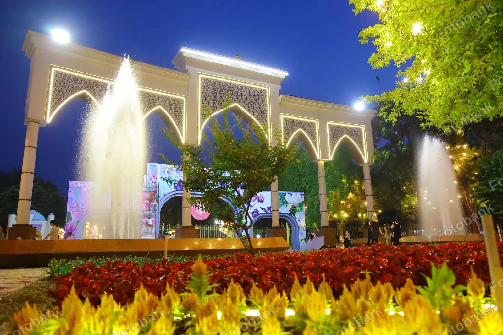 Fountains illuminate park entrance arch