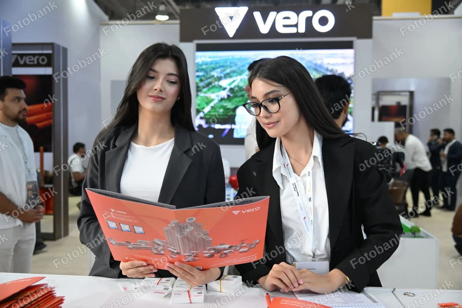 Two women reviewing product catalog