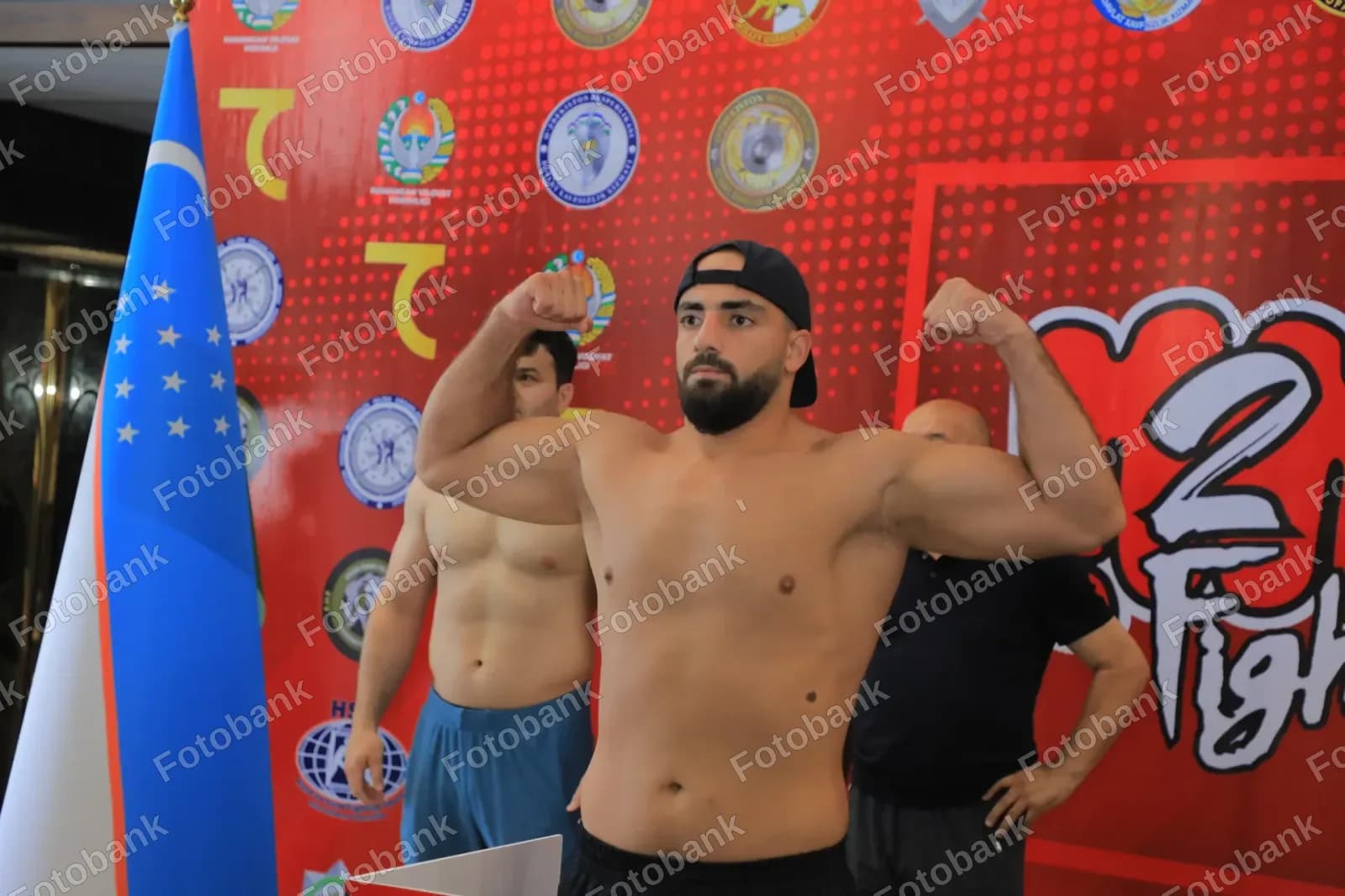Athlete flexes muscles during weigh-in