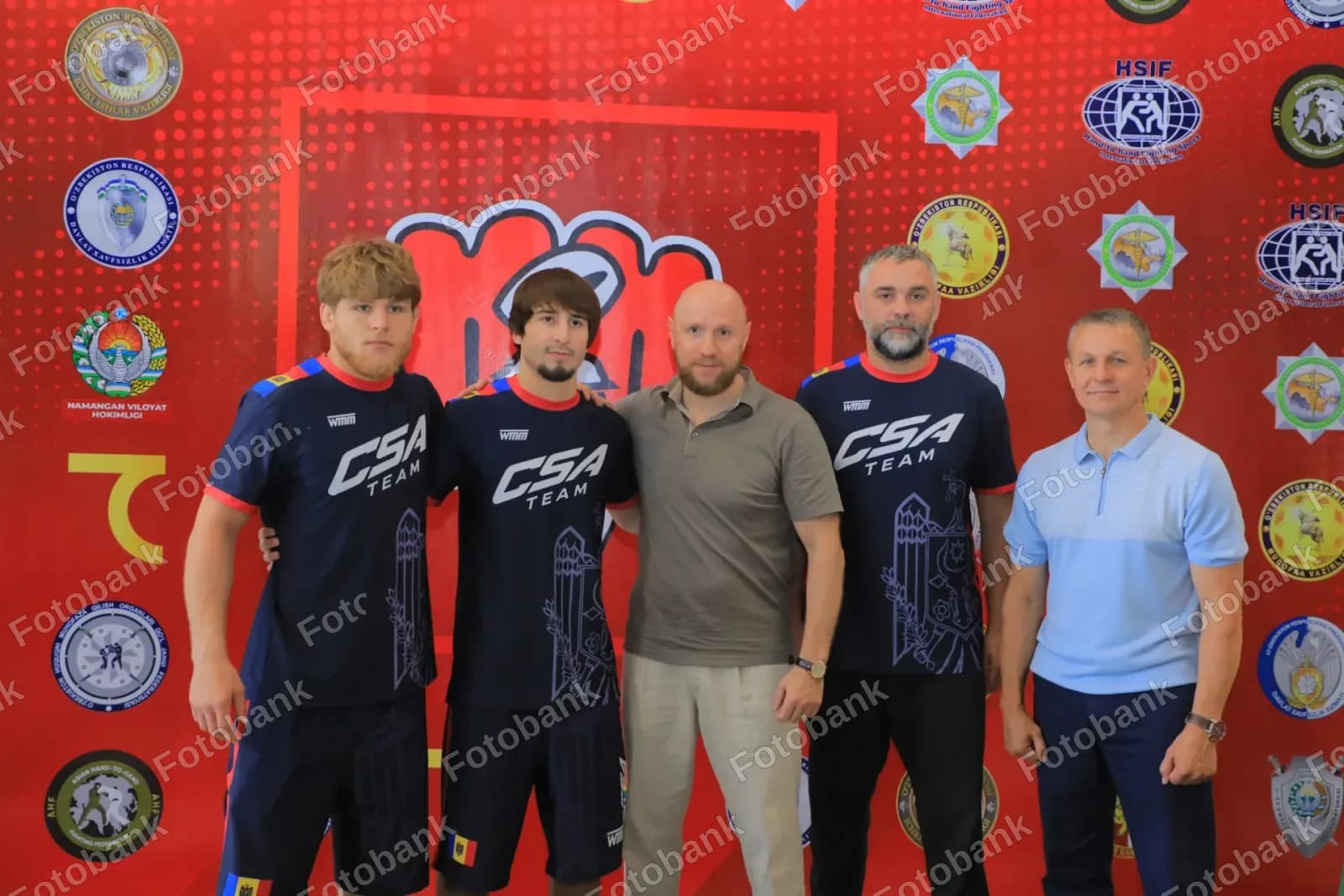 Athletes and coaches posing together