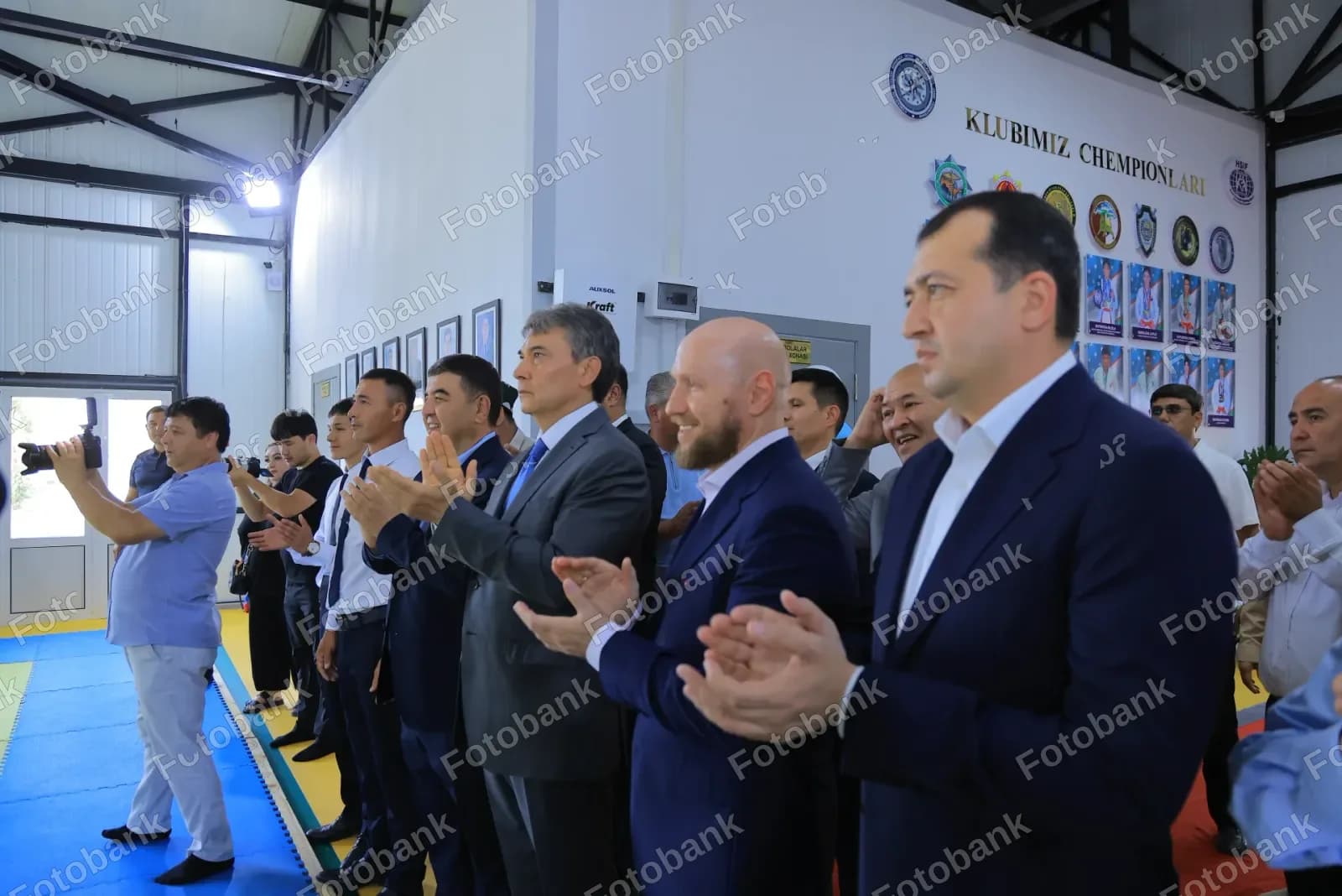 Bir guruh erkaklar ichkarida qarsak chalishmoqda