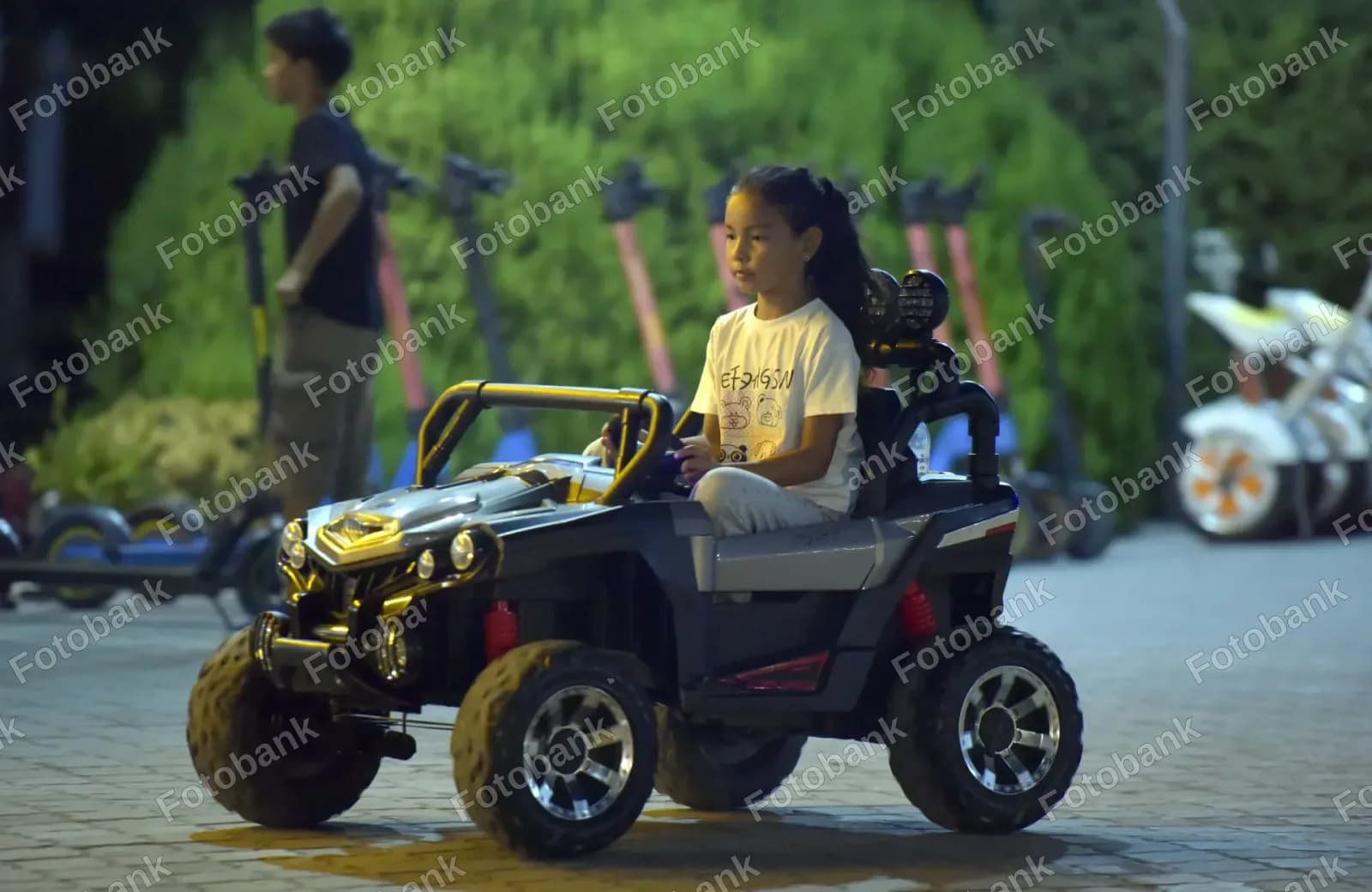 Young girl driving toy car