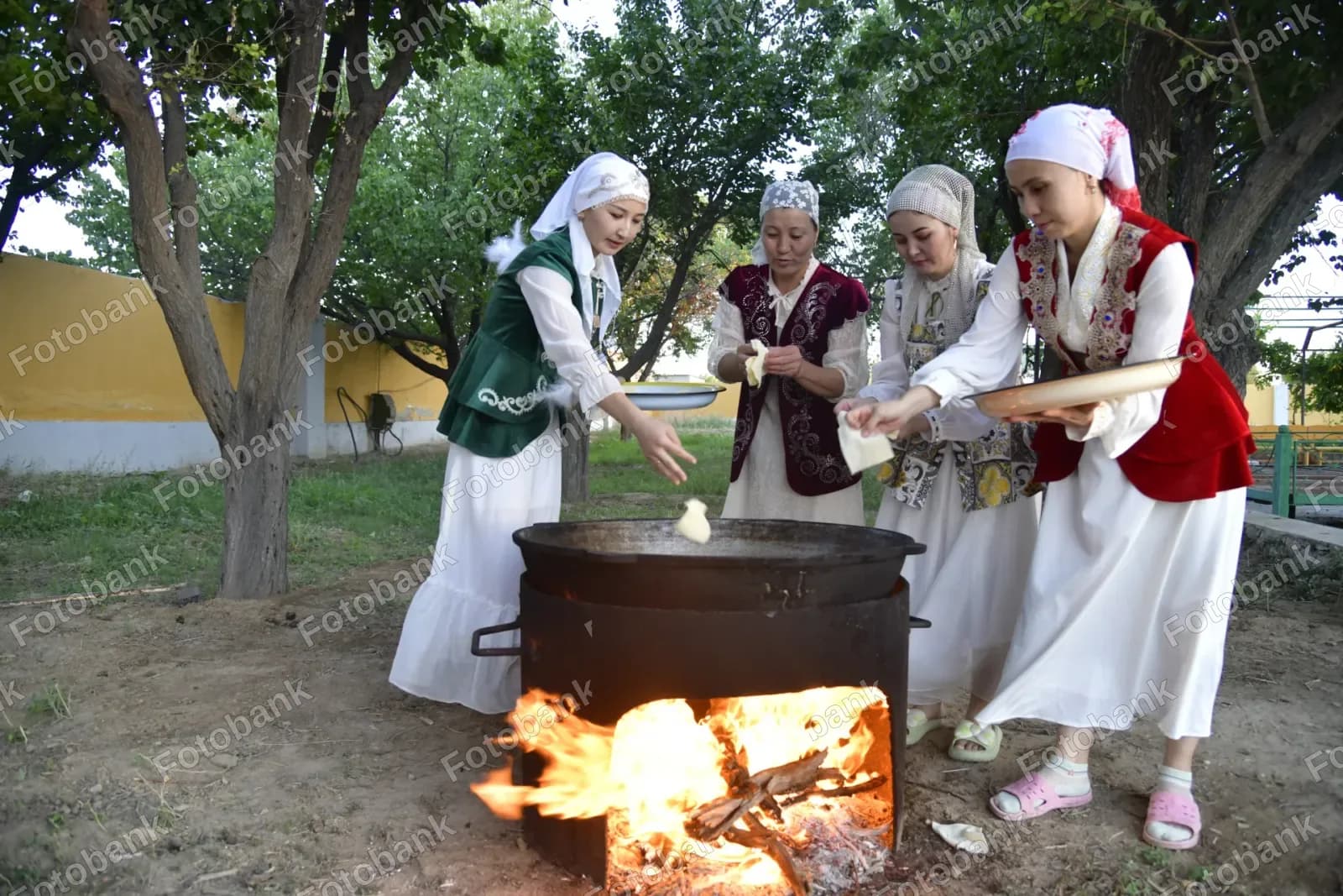 Women cooking traditional food outdoors