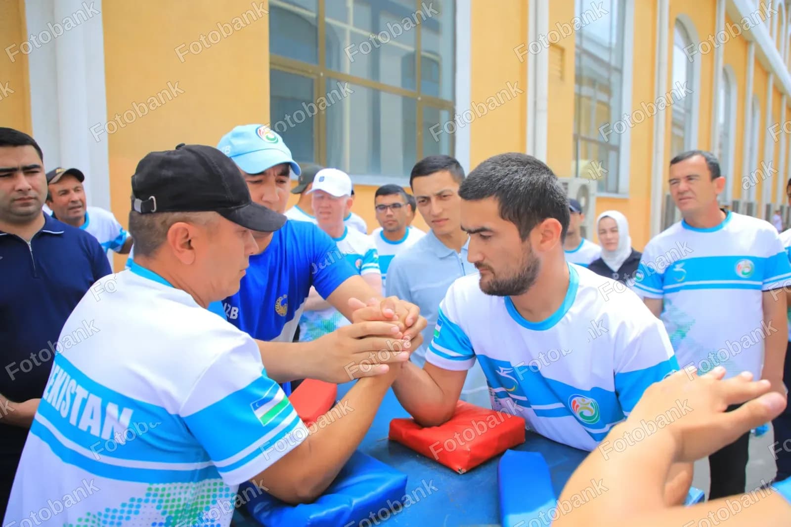 Athletes compete in arm wrestling match