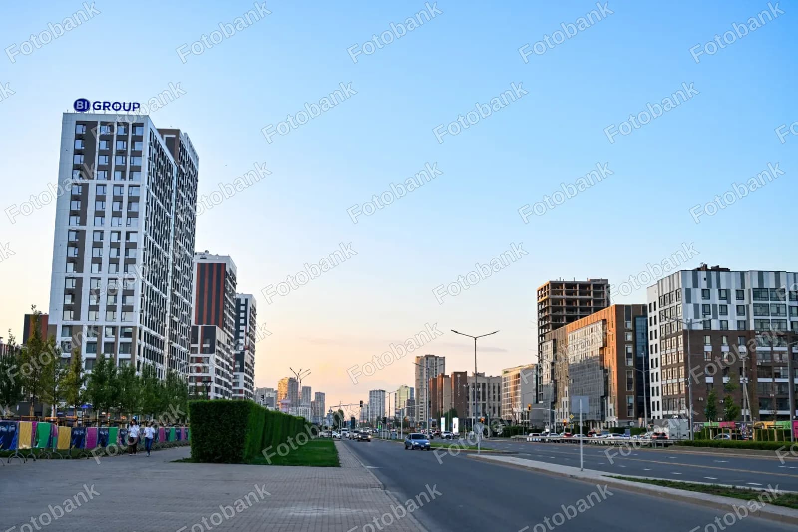 Cars drive along city street